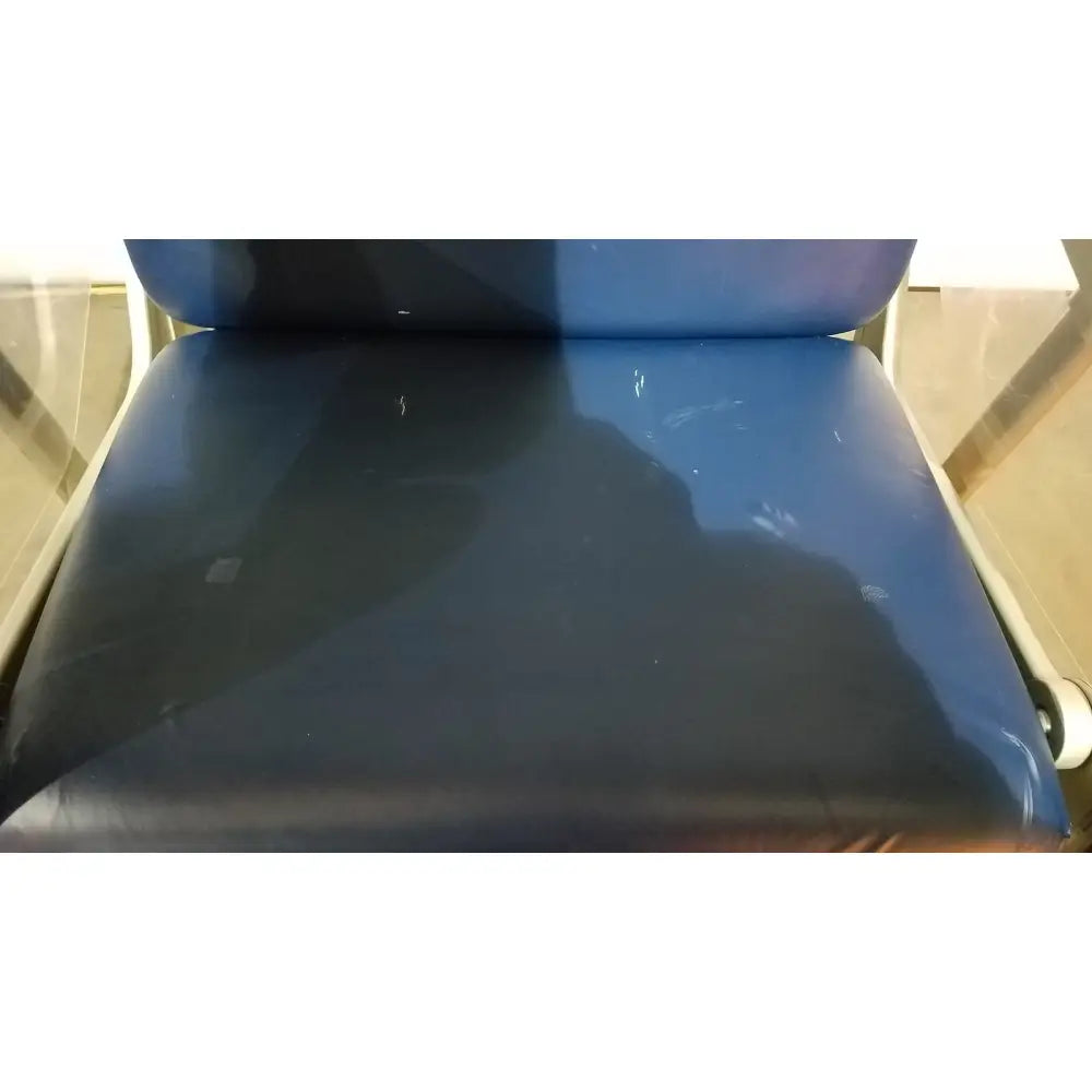 Blue vinyl barton convertible medical chair with slightly worn glossy finish designed for medical use