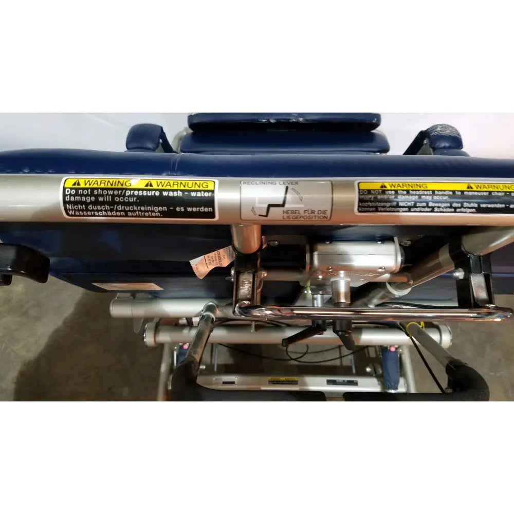 Silver metallic reclining lever with black warning labels on barton convertible medical chair frame