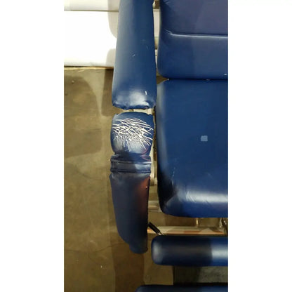 Blue padded armrest with visible wear on barton convertible medical chair designed for treatment use