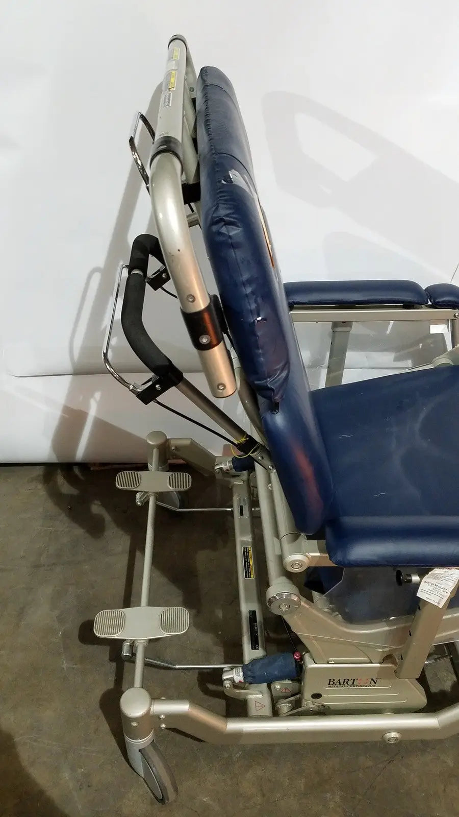 Blue upholstered barton convertible medical chair with silver metal frame and wheels for patient lifting