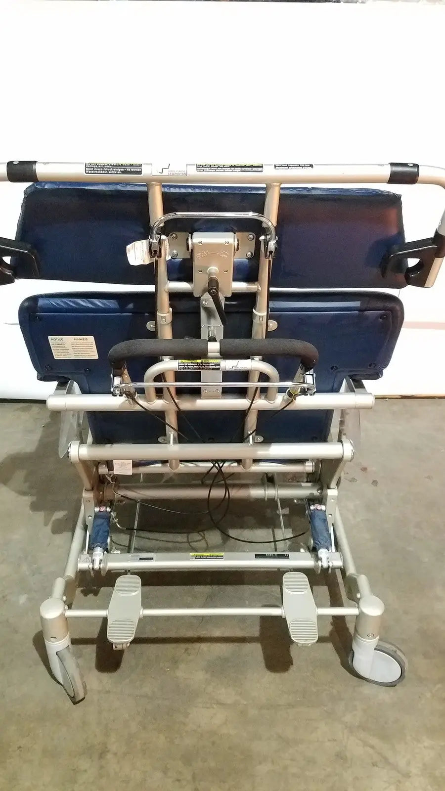 Blue cushioned barton convertible medical chair with silver metal frame and adjustable footrests for patient lifting