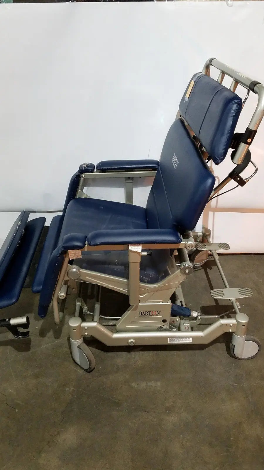 Blue padded barton convertible medical chair with adjustable sections and metal frame for patient comfort