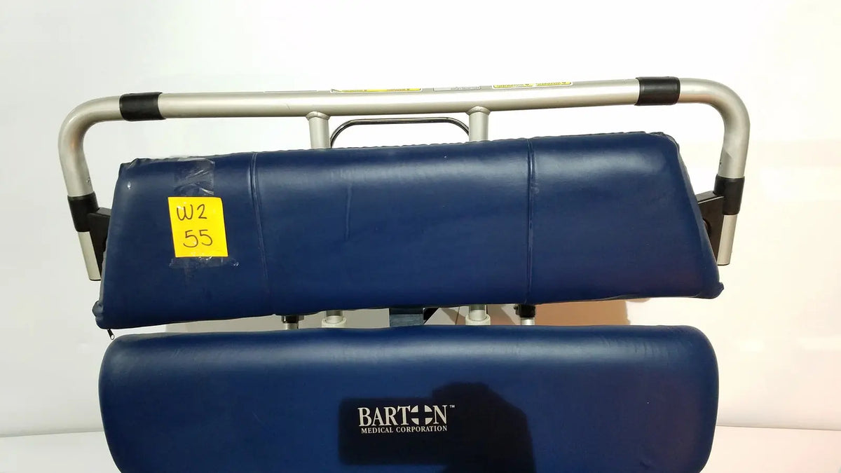 Blue padded patient lift with silver metal frame and black rubber grips on barton convertible medical chair