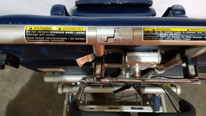 Silver metallic reclining lever with black warning labels on barton convertible medical chair frame