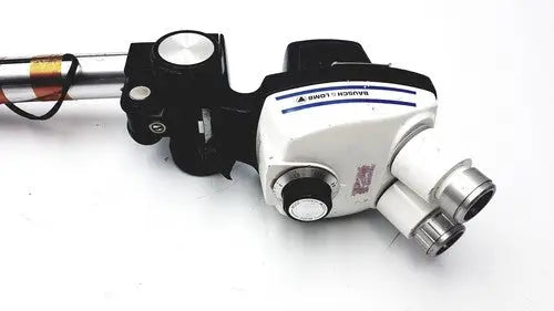 Black and white Bausch & lomb StereoZoom 4 surgical microscope with silver eyepieces and zoom range for reuse medical use