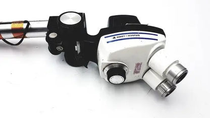 Black and white Bausch & lomb StereoZoom 4 surgical microscope with silver eyepieces and zoom range for reuse medical use