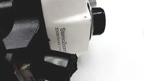 White bausch and lomb stereozoom 4 microscope with black knobs and metallic accents zoom range 0.7x to 3x for reuse medical purposes