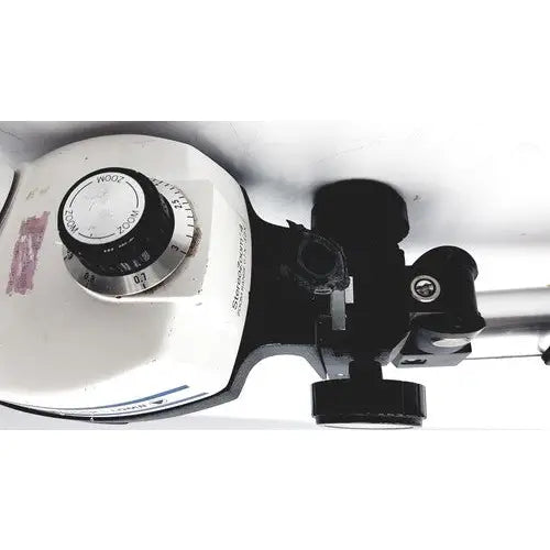 White and black bausch and lomb stereozoom 4 microscope with circular dial and zoom range 0.7x to 3.0x for reuse medical tasks