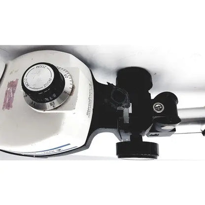 White and black bausch and lomb stereozoom 4 microscope with circular dial and zoom range 0.7x to 3.0x for reuse medical tasks