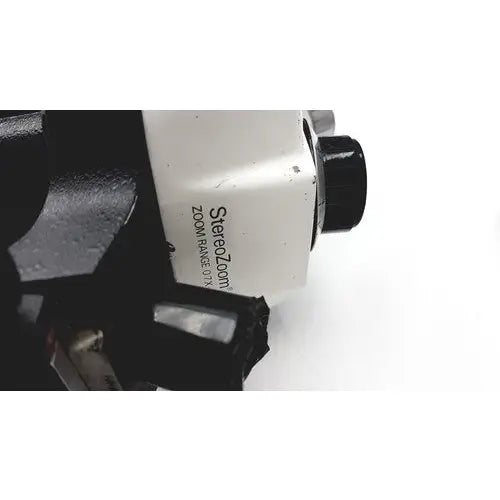 White bausch and lomb stereozoom 4 microscope with black knobs and metallic accents zoom range 0.7x to 3x for reuse medical purposes