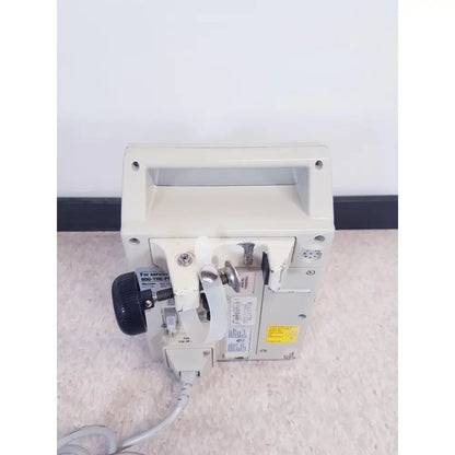 Beige baxter 2m8063 volumetric infusion pump with black knob and silver hardware for precise fluid delivery