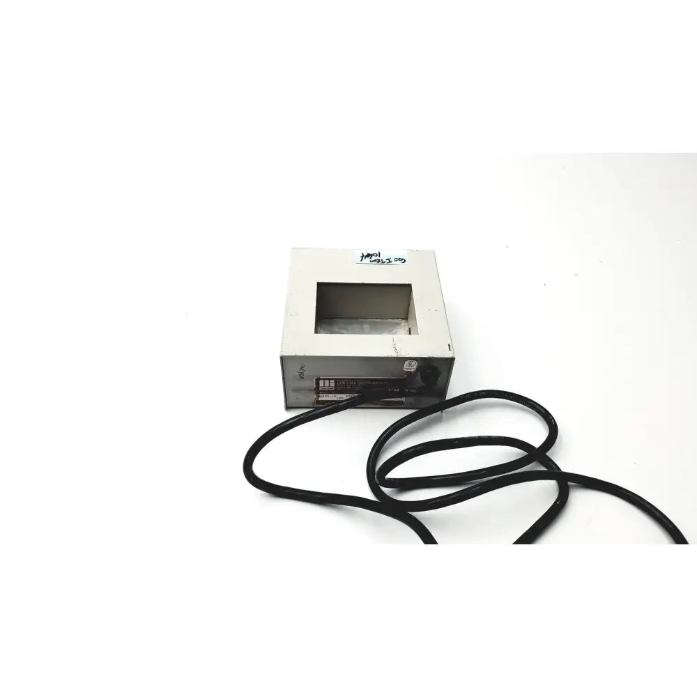 Silver rectangular metal multi-blok heater h2025-1a by baxter scientific products with cutout window and black power cord attached
