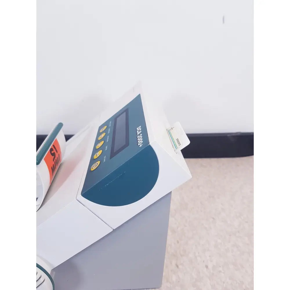 White and teal bayer dca 2000 plus analyzer ref with rectangular display, yellow buttons, and card slot sn50c310536 as is