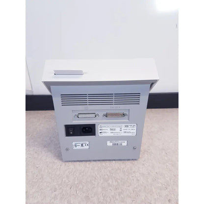 Rear view of gray metallic bayer dca 2000+ analyzer ref featuring two d-sub connectors and ac power input for reuse medical