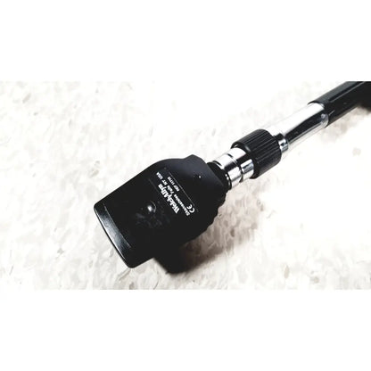 Black tolka luma otoscope with chrome handle and textured grip shown with beckman coulter airfuge ultracentrifuge 60hz 120v
