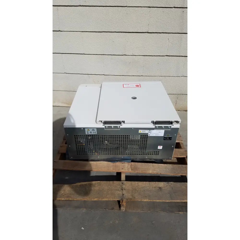 White and gray beckman coulter avanti refrigerated centrifuge with hinged lid and perforated ventilation panel on the back side