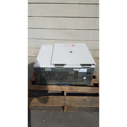 White and gray beckman coulter avanti refrigerated centrifuge with hinged lid and perforated ventilation panel on the back side