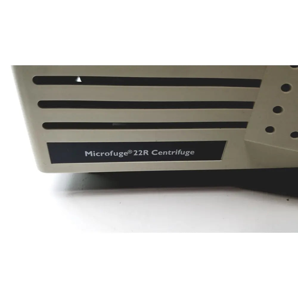 Beige plastic beckman coulter microfuge 22r centrifuge with black horizontal slits and perforated side panel