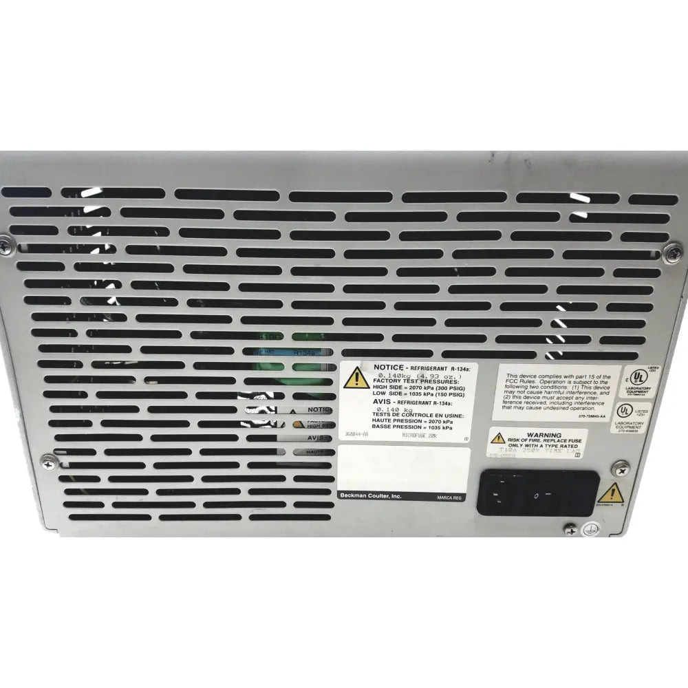 Silver metallic beckman coulter microfuge 22r server rack with perforated grille and multiple warning labels visible from back side