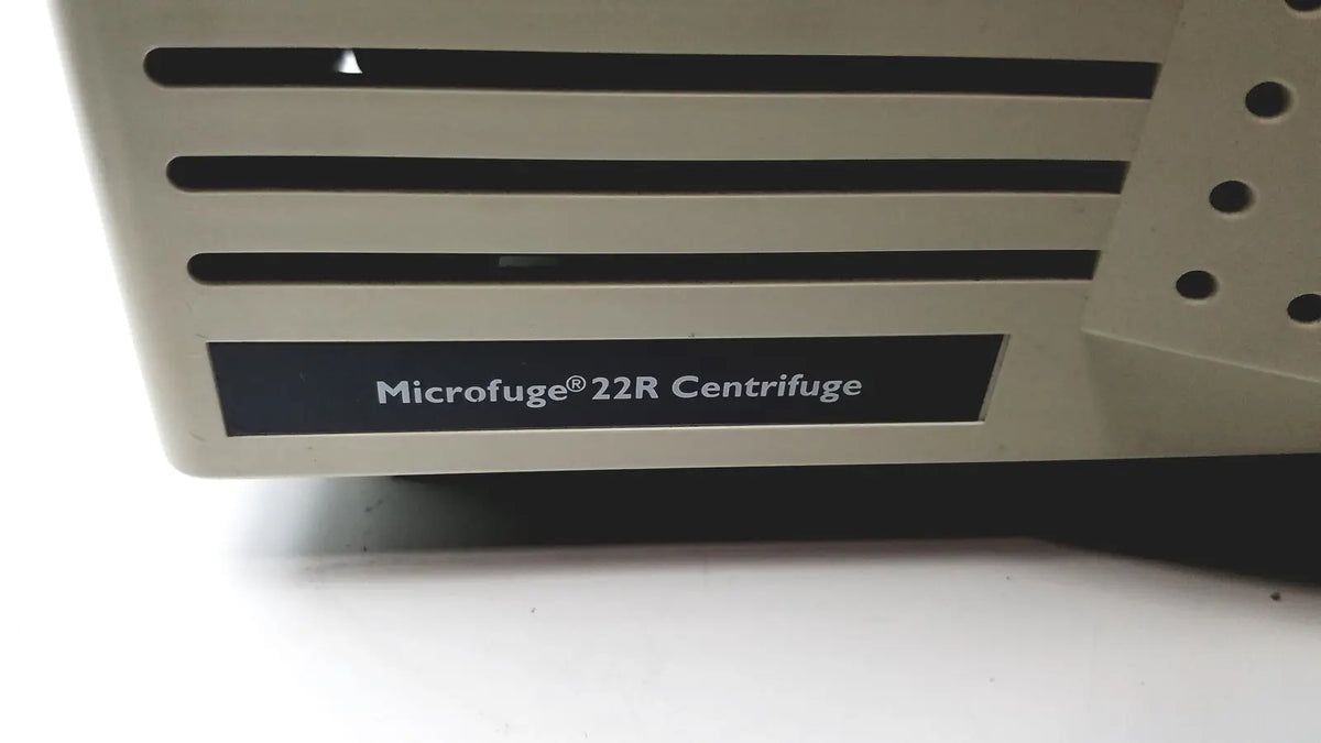 Beige plastic beckman coulter microfuge 22r centrifuge with black horizontal slits and perforated side panel