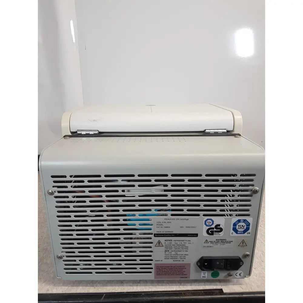 Back side of white industrial-grade power supply unit with vented panel and labels for beckman coulter refrigerated centrifuge microfuge 22r
