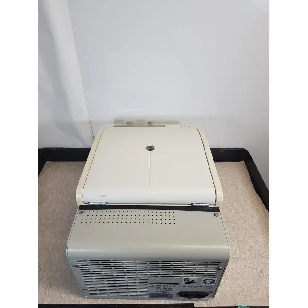 Beige plastic beckman coulter refrigerated centrifuge microfuge 22r with hinged lid and ventilation grilles on sides