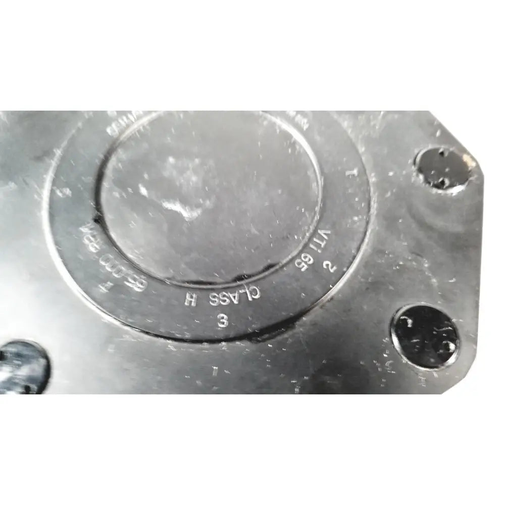 Black metallic beckman coulter ultracentrifuge unit with engraved markings and bolt holes for secure assembly