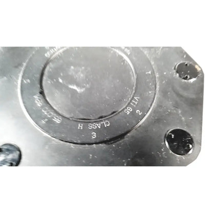 Black metallic beckman coulter ultracentrifuge unit with engraved markings and bolt holes for secure assembly
