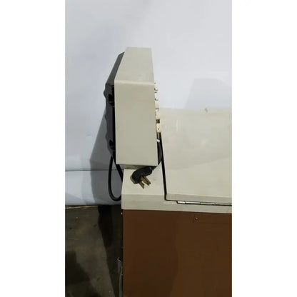 Beige and black beckman j2-21 refrigerated centriifuge showing power cord plugged into side of device