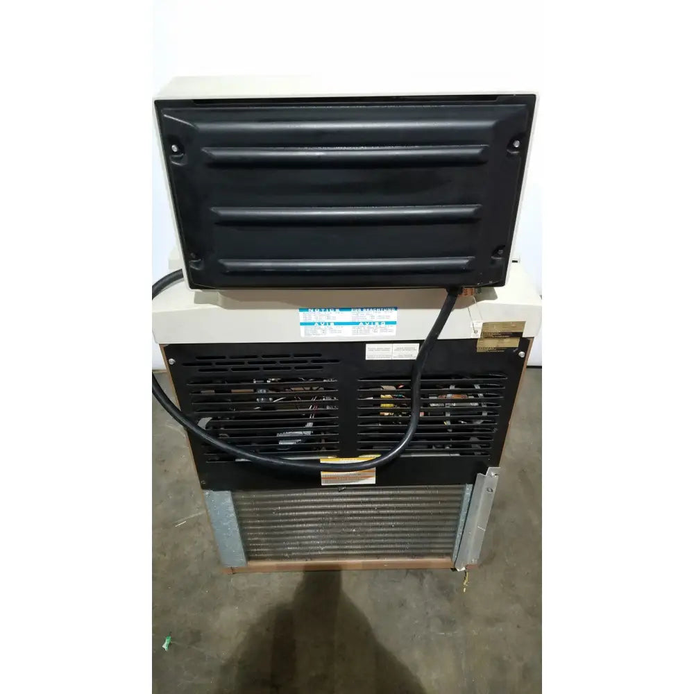 Black and beige beckman j2-21 refrigerated centriifuge rear side with ribbed panel metal grille and visible internal components