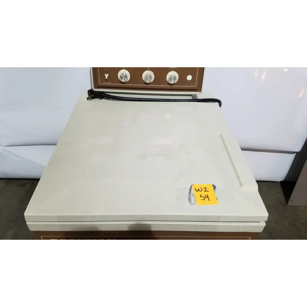 Cream-colored beckman j2-21 refrigerated centriifuge with brown control panel, three dials, and black power cord