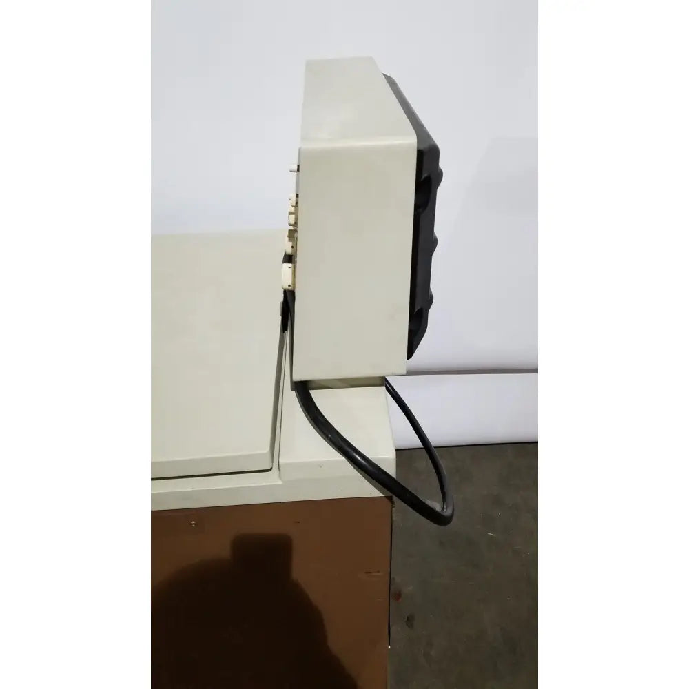 Beige and black vintage crt television with plastic casing and power cord shown as part of beckman j2-21 refrigerated centriifuge setup