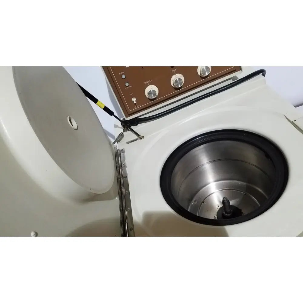 White countertop beckman j2-21 refrigerated centriifuge with brown control panel and stainless steel rotor chamber