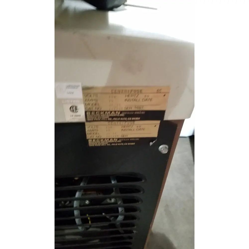 Black beckman j2-21 refrigerated centrifuge with beige label showing model and serial information on the back side