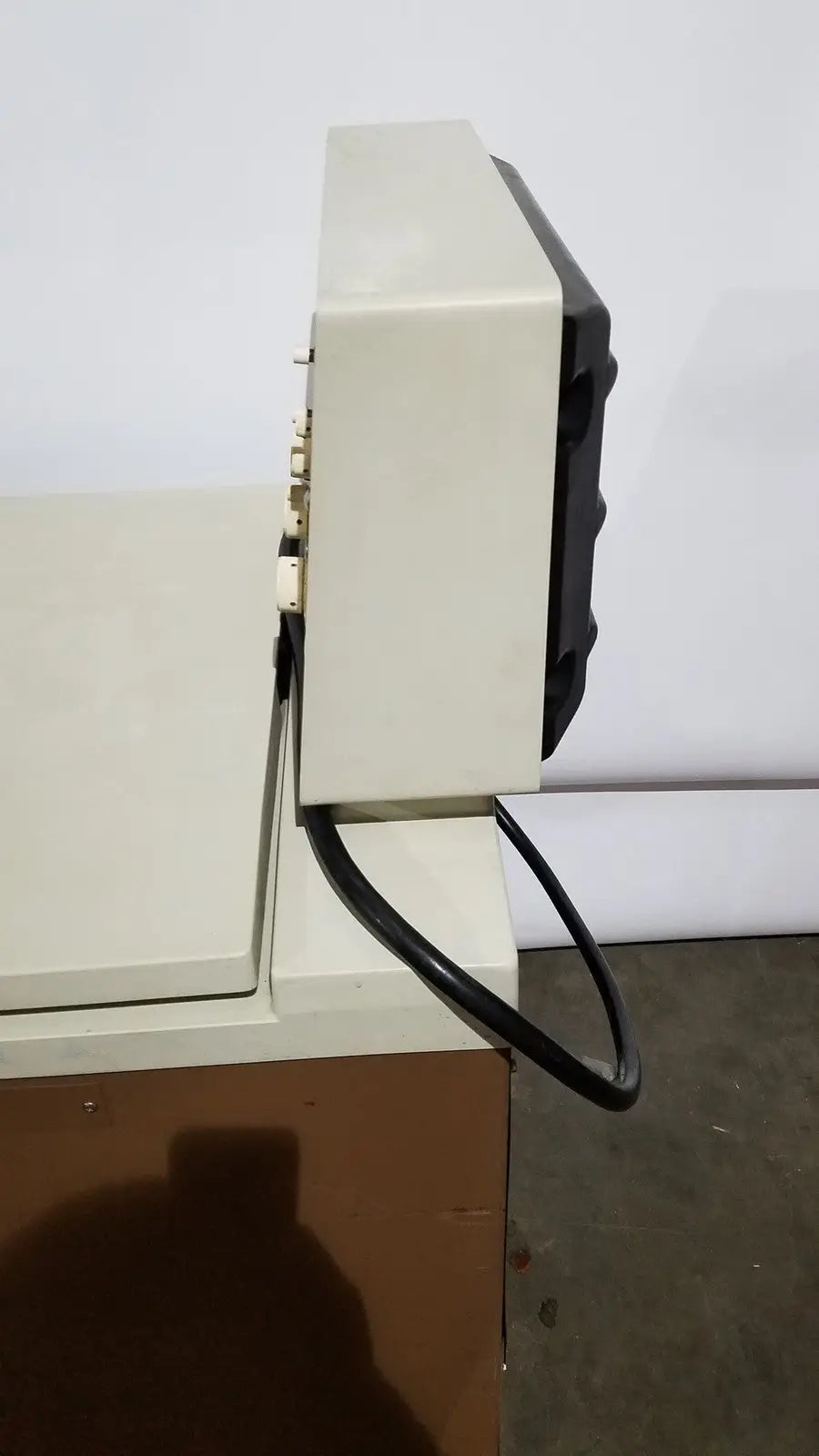 Beige and black vintage crt television with plastic casing and power cord shown as part of beckman j2-21 refrigerated centriifuge setup
