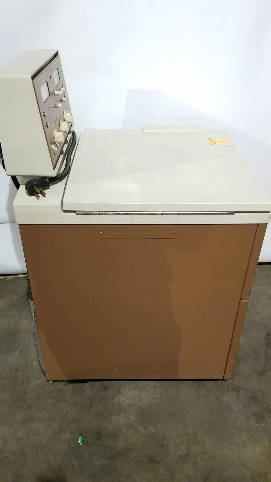 Beige and brown industrial j2-21 refrigerated centriifuge with control panel on top for laboratory refrigeration use