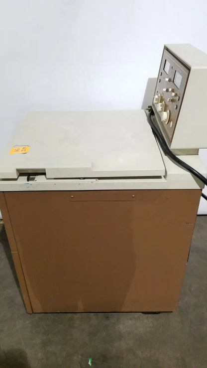 Beige and brown beckman j2-21 refrigerated centriifuge with control panel featuring dials switches and gauges