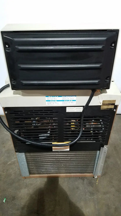 Black and beige beckman j2-21 refrigerated centriifuge rear side with ribbed panel metal grille and visible internal components