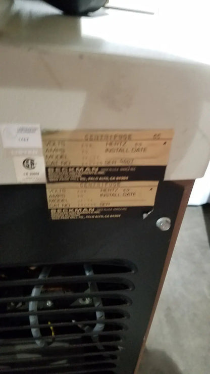 Black beckman j2-21 refrigerated centrifuge with beige label showing model and serial information on the back side