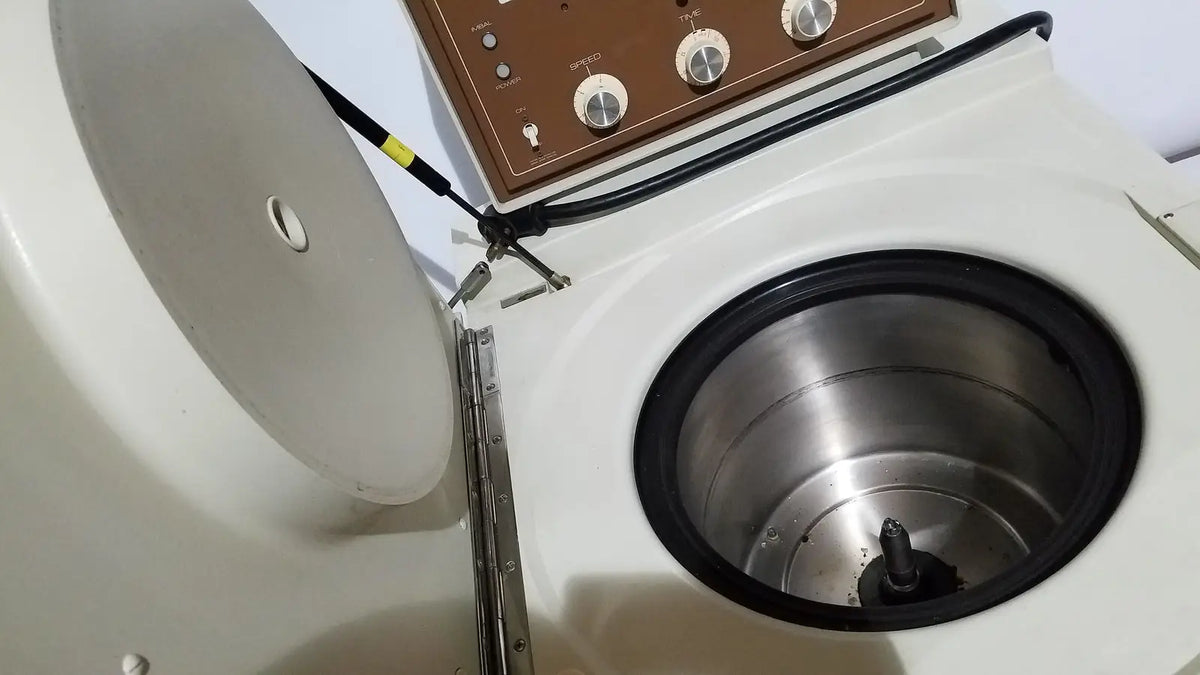 White countertop beckman j2-21 refrigerated centriifuge with brown control panel and stainless steel rotor chamber