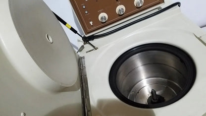 White countertop beckman j2-21 refrigerated centriifuge with brown control panel and stainless steel rotor chamber