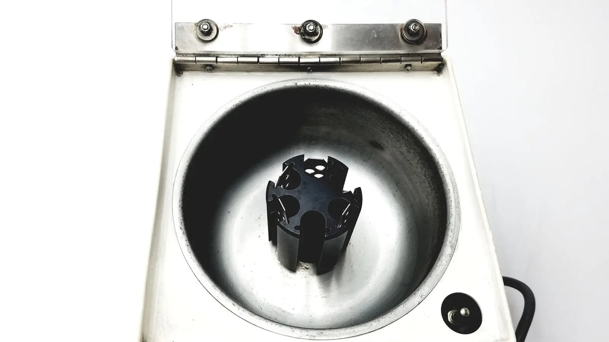 White laboratory centrifuge beckman microfuge with a black 6-position rotor designed for reuse medical applications