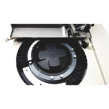 Black circular component with textured cross center and metallic bolts on beckman gold autosampler for hplc laboratory reuse medical