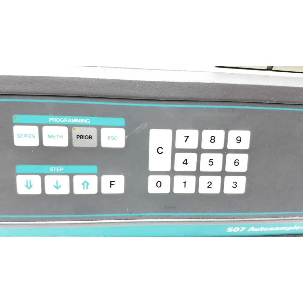 Gray control panel with white buttons and teal accents on beckman system gold autosampler 507 for hplc laboratory use