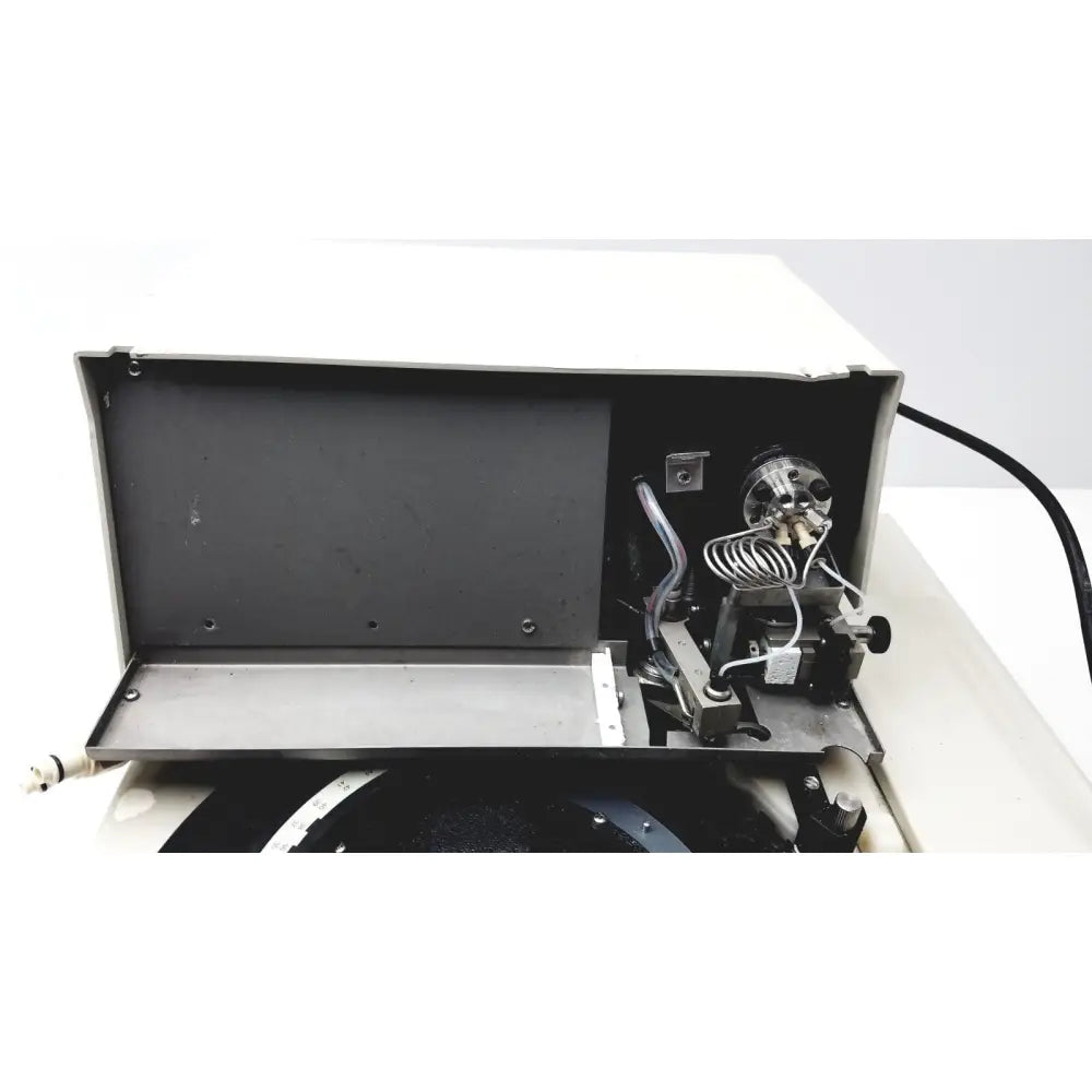 White rectangular Beckman gold autosampler with hinged lid open showing internal components for HPLC laboratory use
