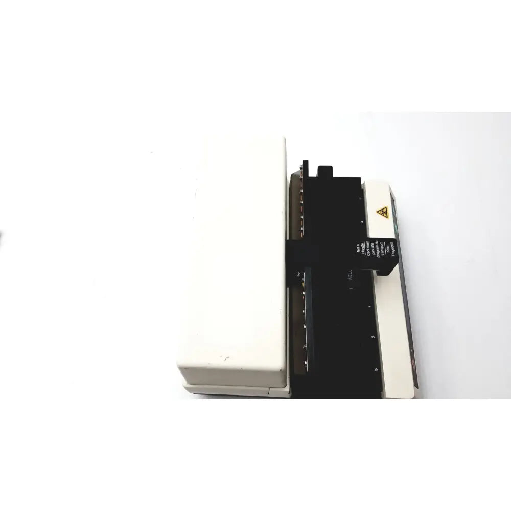 White and black becton dickinson microprobe processor with yellow warning label laboratory equipment side view
