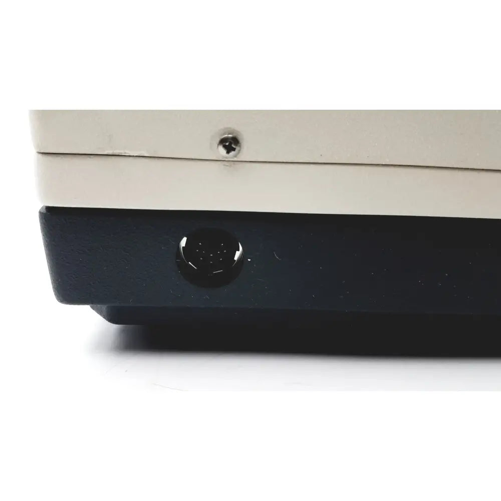 Black circular port on the lower front of a beige becton dickinson 250100 bd microprobe processor laboratory equipment