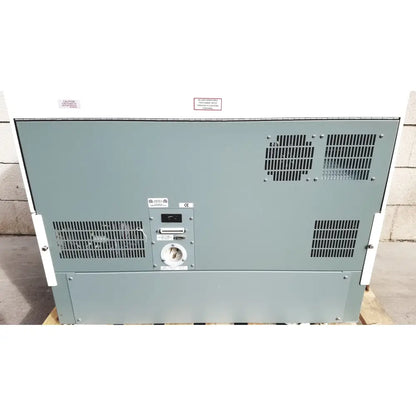 Gray metal industrial generator with ventilation grilles and control panel of becton dickinson facscalibur flow cytometer