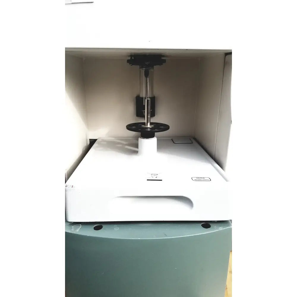 White laboratory instrument with black and silver vertical column and circular base of becton dickinson facscalibur flow cytometer