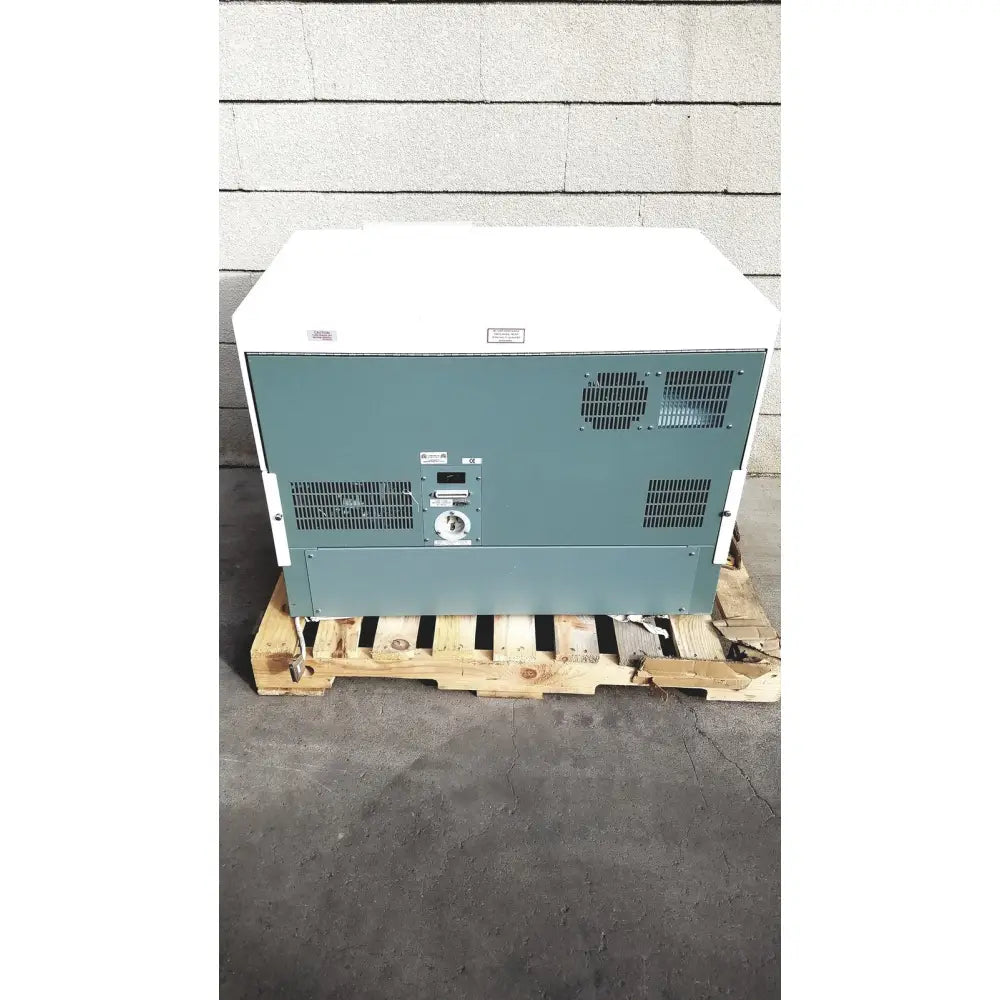White and teal becton dickinson facscalibur flow cytometer rear side showing ventilation grilles control panel and circular dial